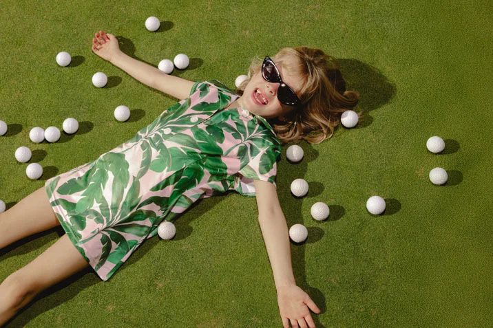 A girl golfing.