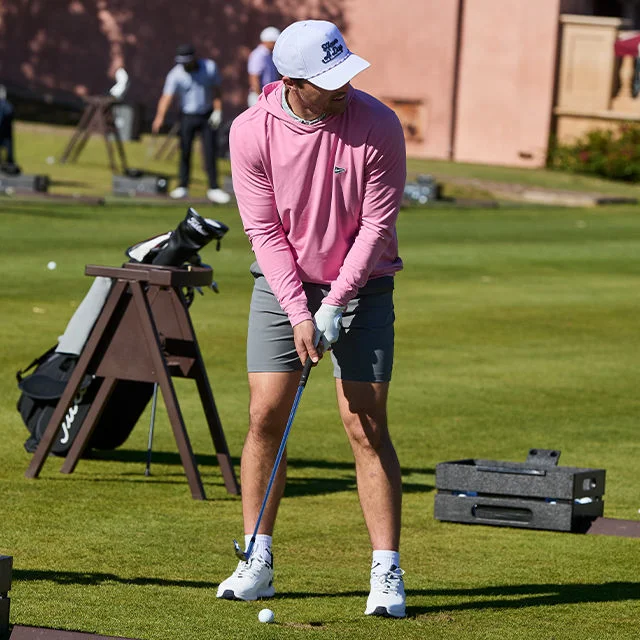 A man hitting an iron at a range.