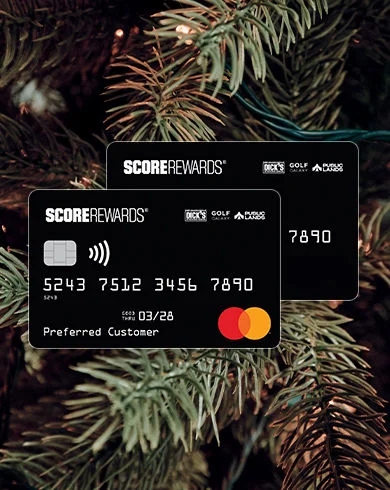 Two men fist bumping on a golf course.