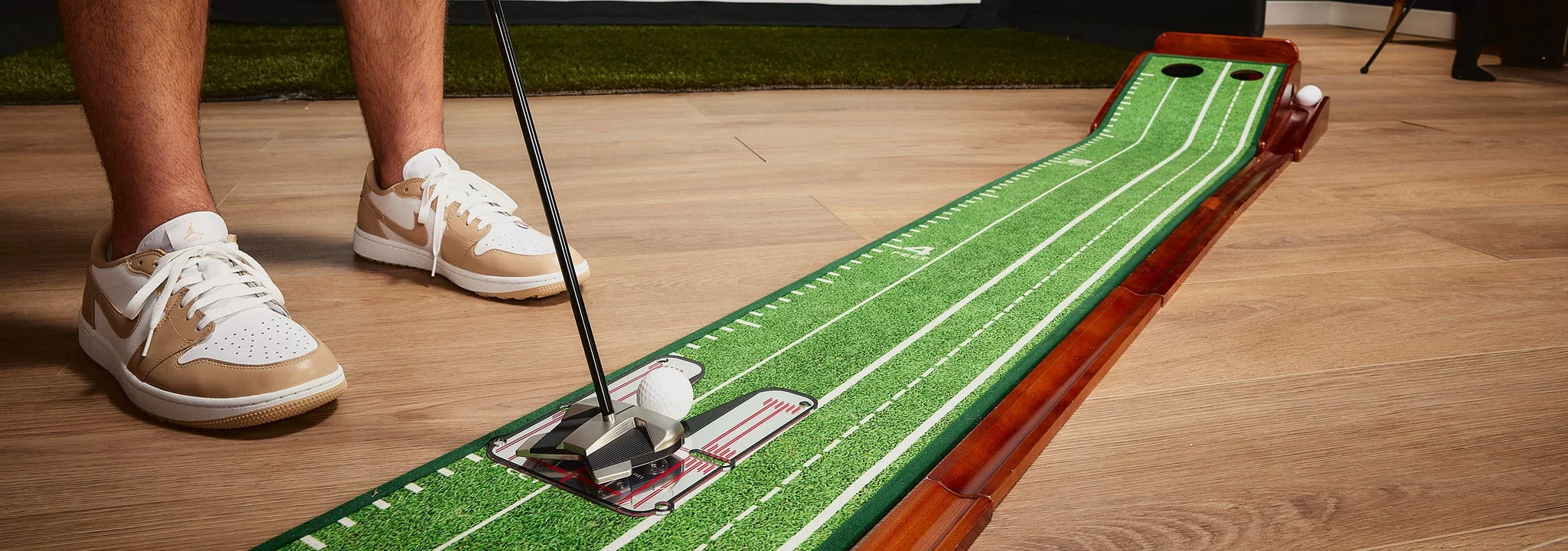 Woman practicing golf swing with simulator